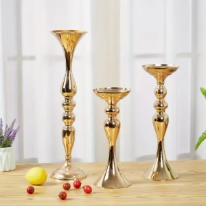 Gold candle holders on wooden table.